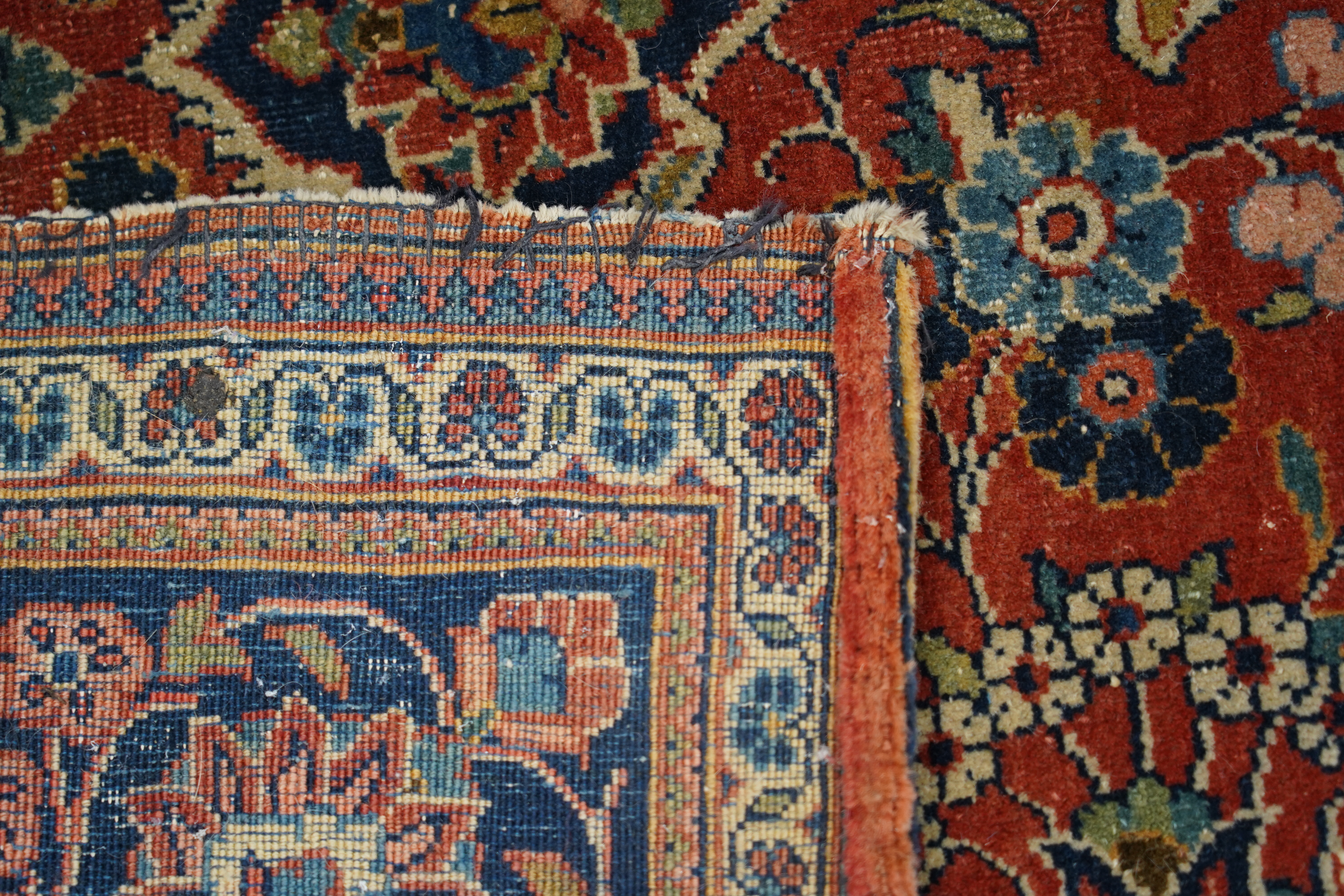 A pair of antique Tabriz brick red ground rugs, 200 x 136cm. Condition - fair